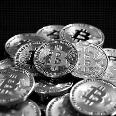 Monochrome image of cryptocurrency coins with pixel screen-dot texture and neon accents